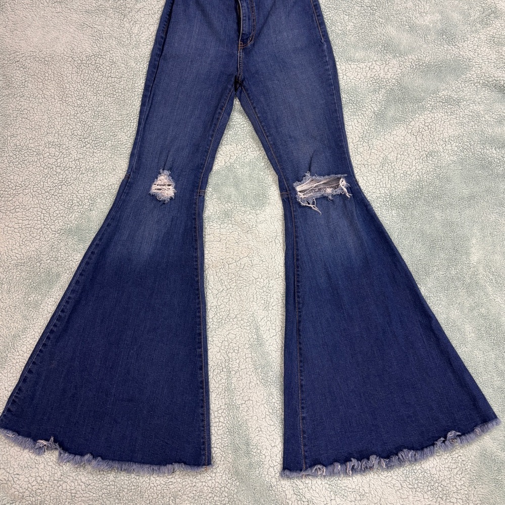 Vibrant brand Mega Flared Blue Jeans with Distressed Details.